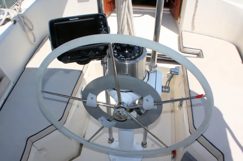 Slide: The Image of Steering wheel and navigation equipment on a 2004 Pacific Seacraft 31 sailboat. - 19
