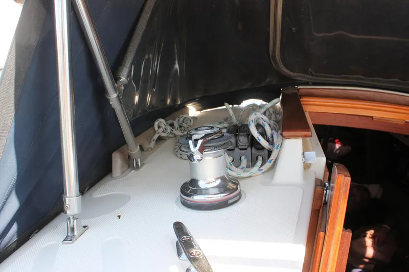 Slide: The Image of 2004 Pacific Seacraft 31 sailboat cockpit with winch and ropes. - 23