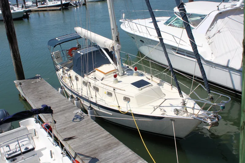 Slide: The Image of 2004 Pacific Seacraft 31 sailboat docked at marina, surrounded by other boats. - 3