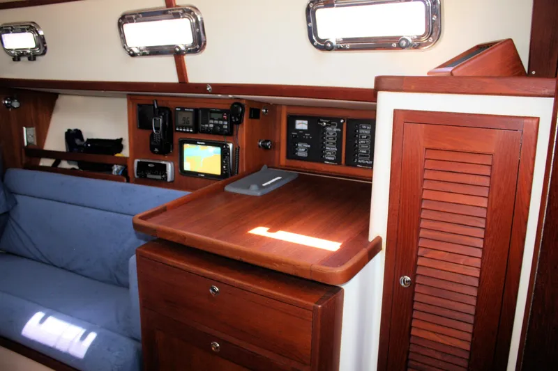 Slide: The Image of Interior of 2004 Pacific Seacraft 31 sailboat with navigation equipment and wooden cabinetry. - 36