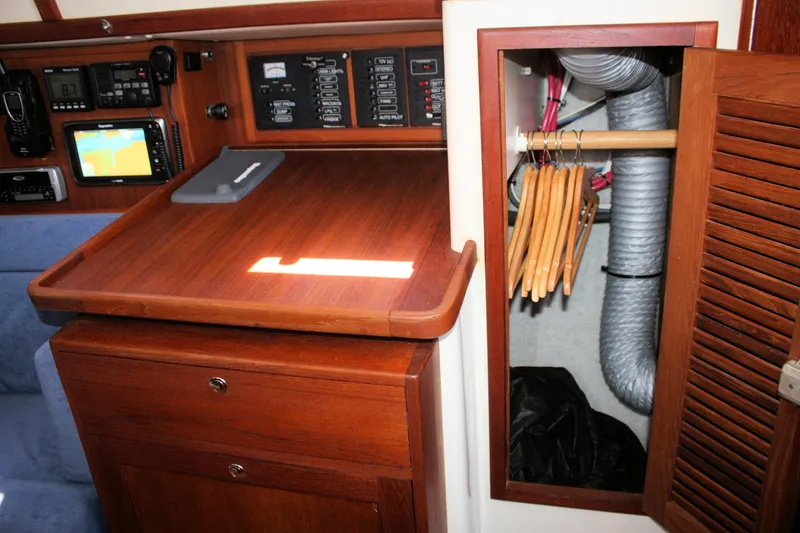 Slide: The Image of Navigation station and closet inside a 2004 Pacific Seacraft 31 sailboat. - 37