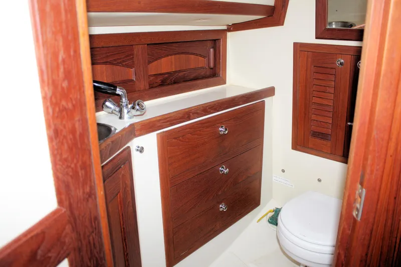Slide: The Image of Interior of 2004 Pacific Seacraft 31 sailboat bathroom with wooden cabinetry and fixtures. - 39