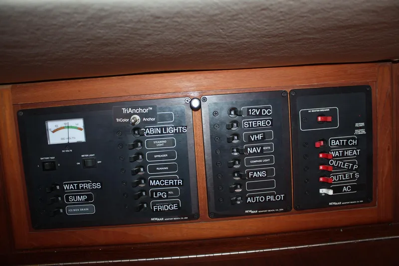 Slide: The Image of Electrical control panel on a 2004 Pacific Seacraft 31 sailboat, featuring various switches and gauges. - 48