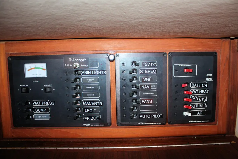 Slide: The Image of Electrical control panel on a 2004 Pacific Seacraft 31 sailboat, featuring various switches and indicators. - 49