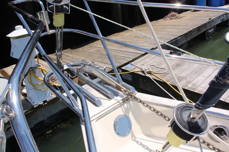 Slide: The Image of 2004 Pacific Seacraft 31 sailboat docked, featuring stainless steel railings and deck equipment. - 6