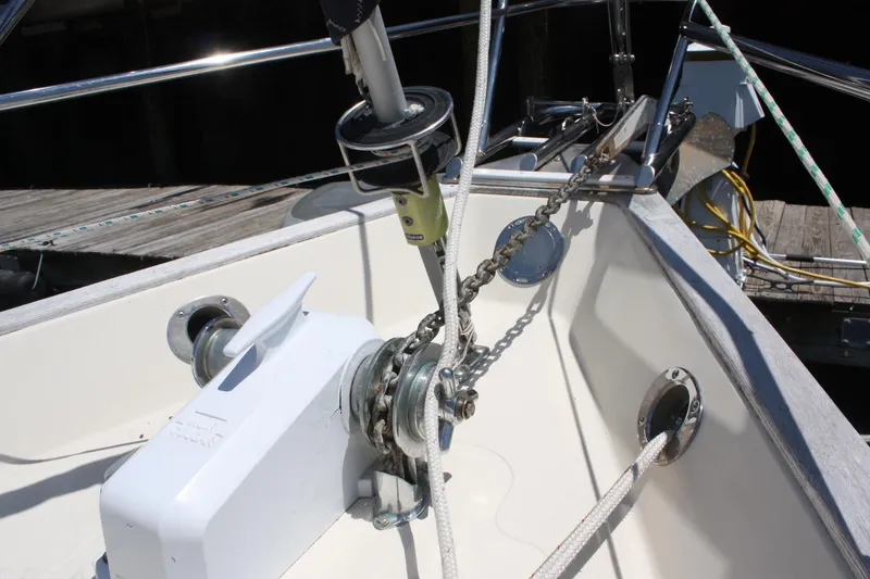 Slide: The Image of Anchor windlass on 2004 Pacific Seacraft 31 sailboat, docked with visible ropes and chains. - 7