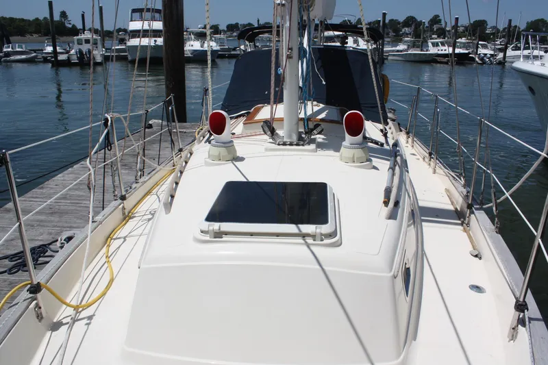 Slide: The Image of 2004 Pacific Seacraft 31 sailboat docked at marina, showcasing deck and rigging. - 9