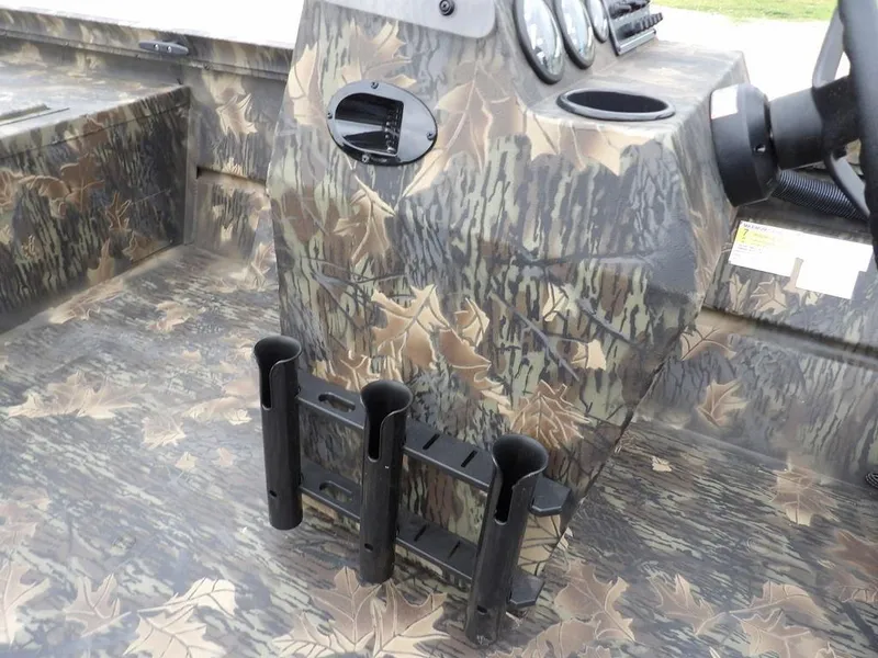 Slide: The Image of 2025 Crestliner 2070 Retriever SCHD boat interior with camouflage design and rod holders. - 15