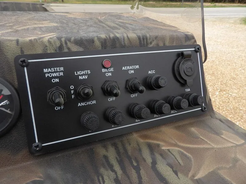 Slide: The Image of Control panel of 2025 Crestliner 2070 Retriever SCHD boat with switches and 12V outlet. - 16