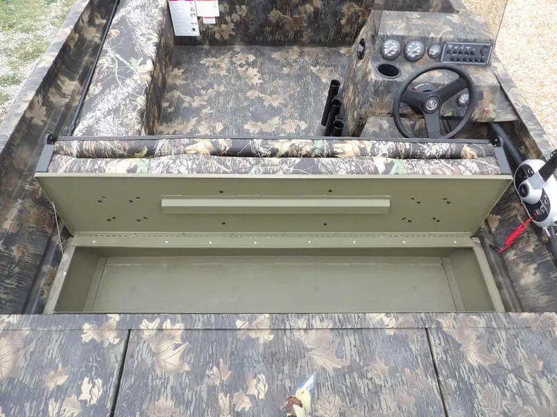 Slide: The Image of 2025 Crestliner 2070 Retriever SCHD boat interior with camouflage design and steering console. - 18