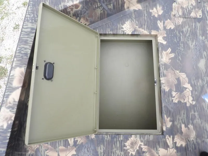 Slide: The Image of Open storage compartment on 2025 Crestliner 2070 Retriever SCHD boat with camouflage design. - 27