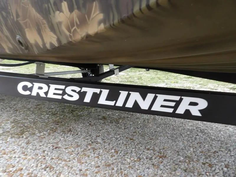 Slide: The Image of 2025 Crestliner 2070 Retriever SCHD boat trailer on gravel surface. - 32