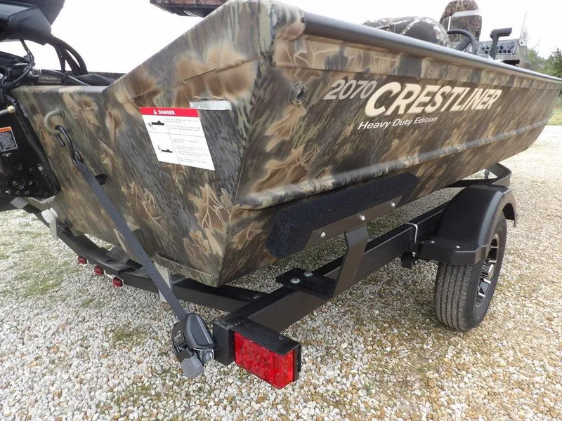 Slide: The Image of 2025 Crestliner 2070 Retriever SCHD boat with camouflage design on a trailer. - 35