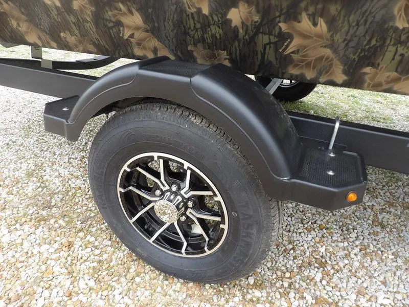 Slide: The Image of 2025 Crestliner 2070 Retriever SCHD trailer wheel with camouflage design and black fender. - 39