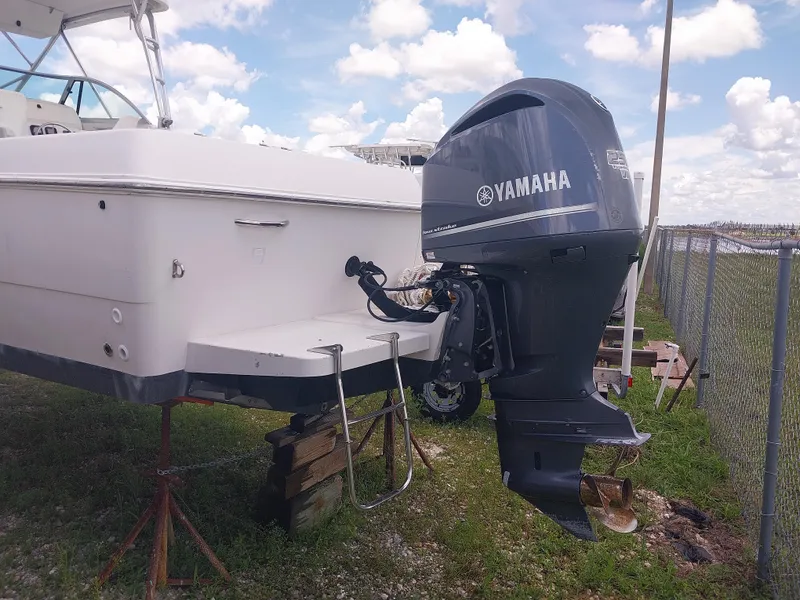 Slide: The Image of 1997 Pro-Line 251 Walkaround boat with Yamaha outboard motor, parked on stands. - 3