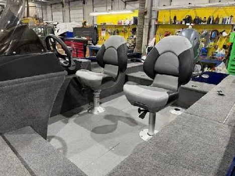 Slide: The Image of 2023 G3 Angler V164 C boat interior with two gray seats in a workshop setting. - 2