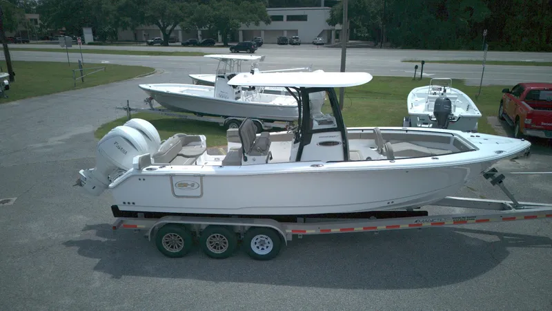 The Image of 2026 Sea Hunt Ultra 265 SE boat on trailer, parked outdoors. - 0