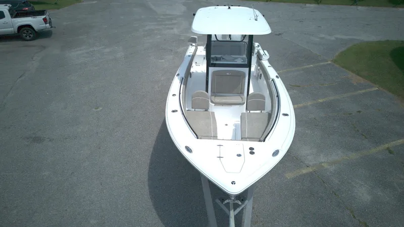 Slide: The Image of 2026 Sea Hunt Ultra 265 SE boat, aerial view, parked on pavement. - 2