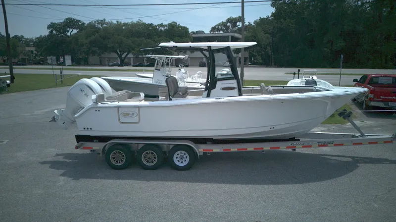Slide: The Image of 2026 Sea Hunt Ultra 265 SE boat on a trailer in a parking lot. - 5