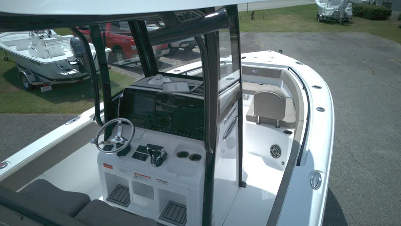 Slide: The Image of 2026 Sea Hunt Ultra 265 SE boat interior with steering console and seating area. - 8