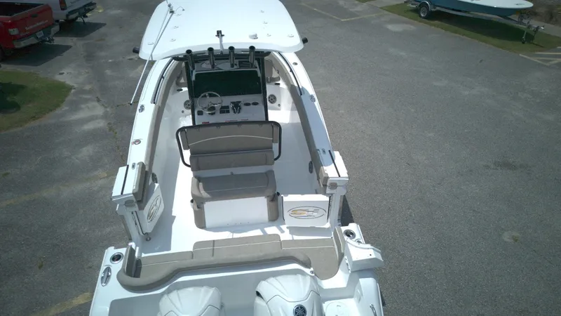 Slide: The Image of 2026 Sea Hunt Ultra 265 SE boat, aerial view, parked on asphalt. - 9