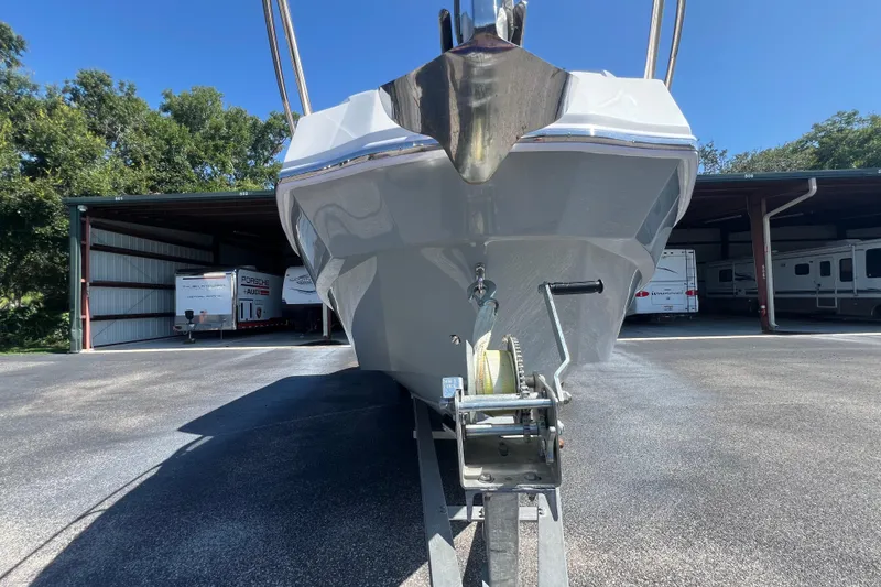 Slide: The Image of 2024 NX Boats 290 Exclusive on trailer, parked in storage facility. - 12