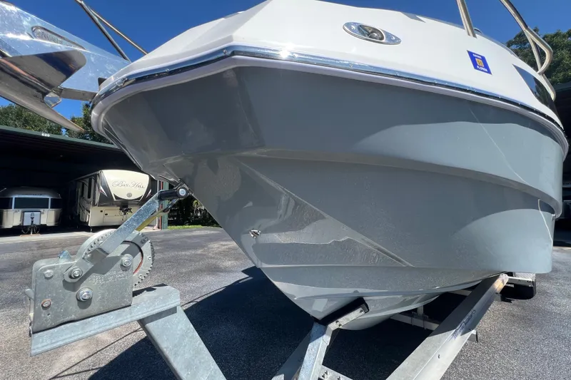 Slide: The Image of 2024 NX Boats 290 Exclusive on trailer, showcasing sleek hull design. - 13