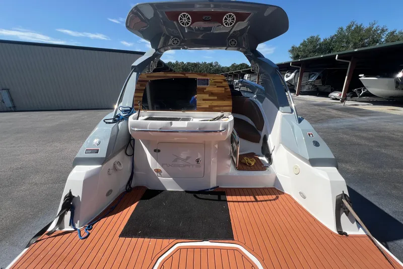 Slide: The Image of 2024 NX Boats 290 Exclusive, luxury deck view with modern amenities and sleek design. - 16