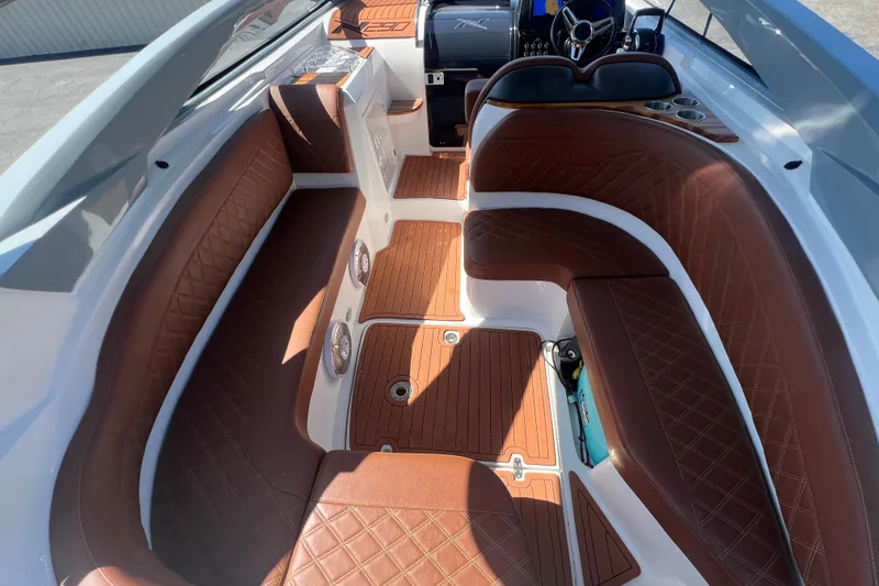 Slide: The Image of 2024 NX Boats 290 Exclusive interior with luxurious brown leather seating and modern dashboard. - 19