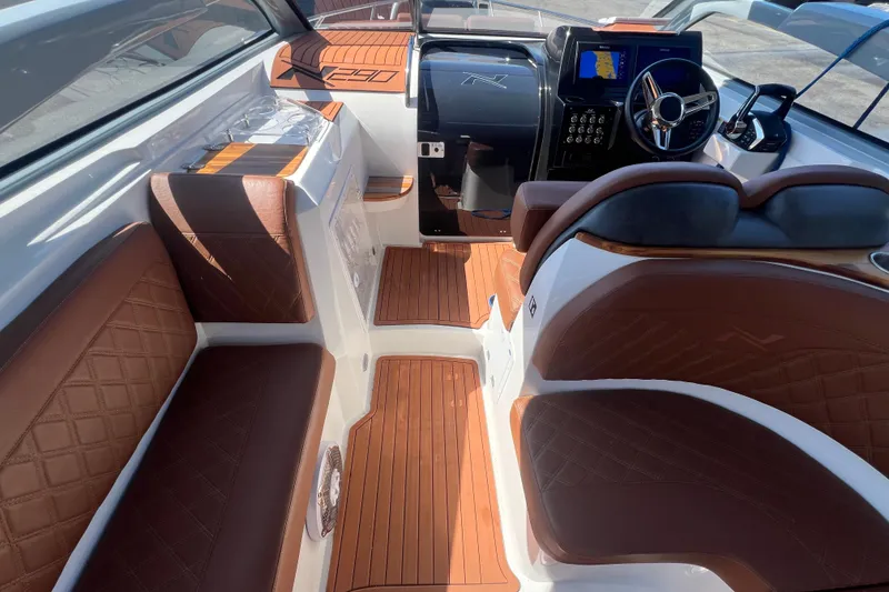 Slide: The Image of 2024 NX Boats 290 Exclusive interior with luxurious brown leather seating and modern dashboard. - 20