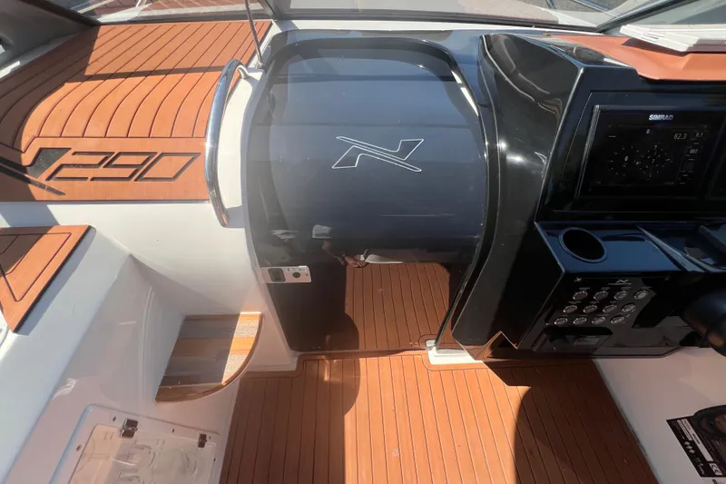 Slide: The Image of 2024 NX Boats 290 Exclusive dashboard with wood accents and modern controls. - 25