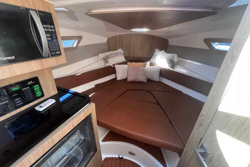 Slide: The Image of 2024 NX Boats 290 Exclusive cabin interior with cozy seating and modern amenities. - 27