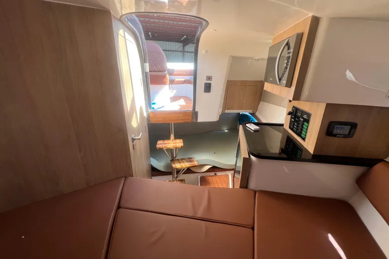 Slide: The Image of Interior of 2024 NX Boats 290 Exclusive, featuring modern design and comfortable seating. - 30