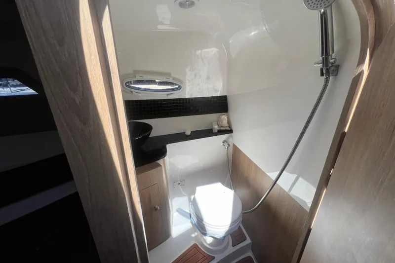 Slide: The Image of 2024 NX Boats 290 Exclusive bathroom with modern fixtures and natural lighting. - 34