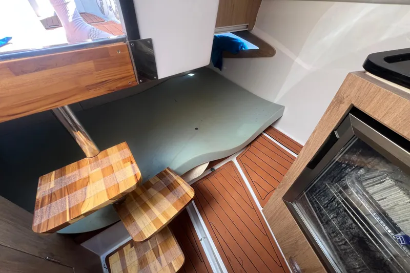 Slide: The Image of 2024 NX Boats 290 Exclusive interior with wooden steps and modern design. - 35