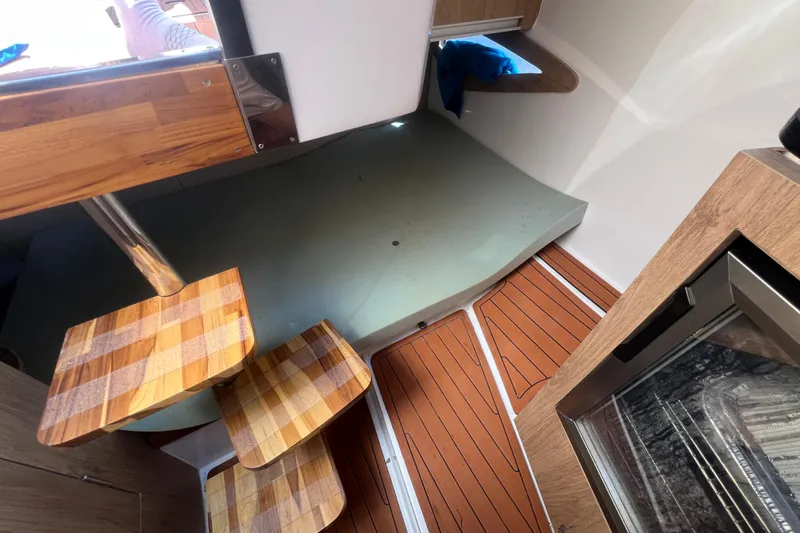 Slide: The Image of Interior of 2024 NX Boats 290 Exclusive, featuring wooden steps and modern design elements. - 36