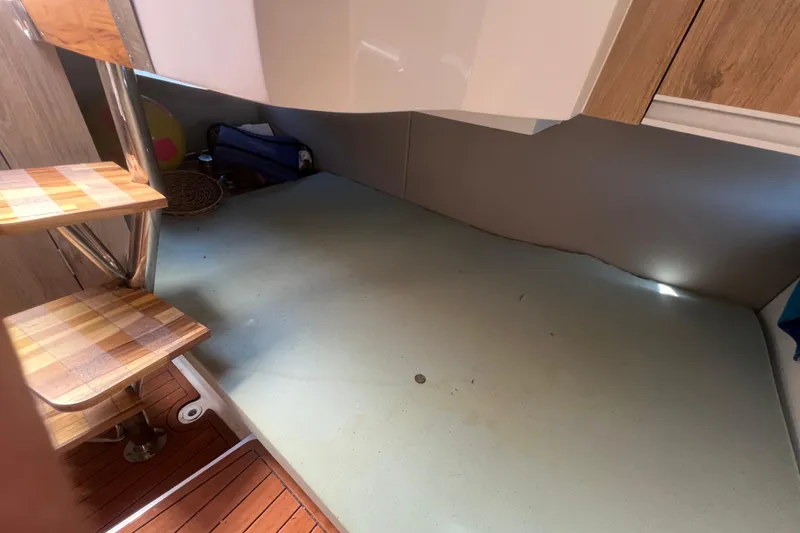 Slide: The Image of Interior of 2024 NX Boats 290 Exclusive with wooden steps and modern design. - 37