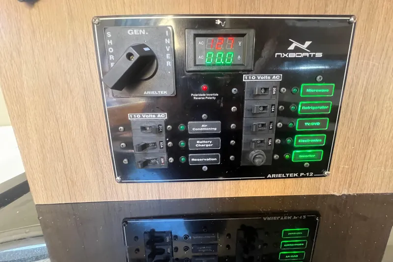 Slide: The Image of Electrical control panel of 2024 NX Boats 290 Exclusive, featuring various switches and indicators. - 39