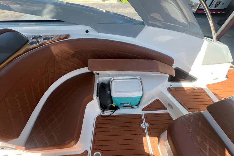 Slide: The Image of 2024 NX Boats 290 Exclusive interior with brown leather seating and wood flooring. - 40