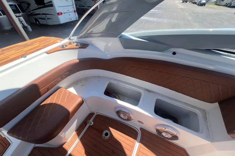 Slide: The Image of 2024 NX Boats 290 Exclusive interior with brown leather seating and wood accents. - 44