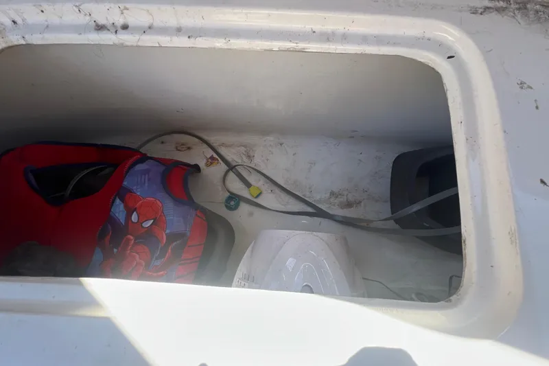 Slide: The Image of Storage compartment of 2024 NX Boats 290 Exclusive with life jacket and cables. - 46