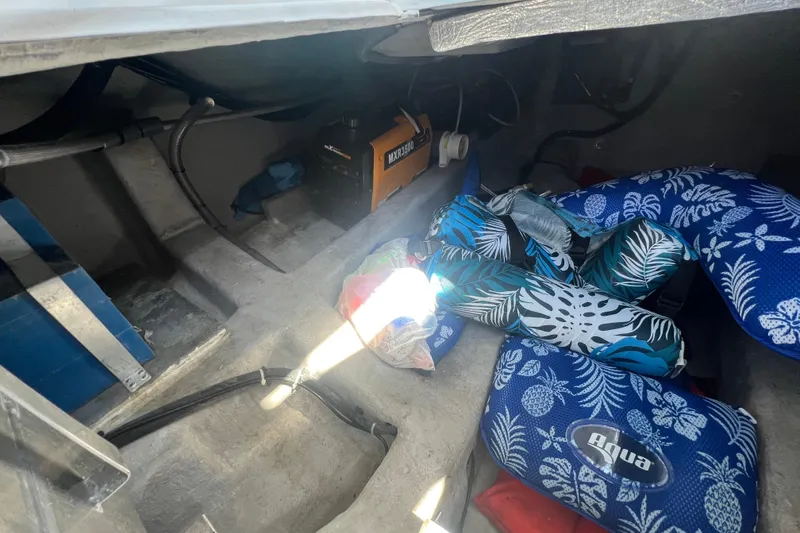 Slide: The Image of Interior storage of 2024 NX Boats 290 Exclusive with colorful cushions and equipment. - 50