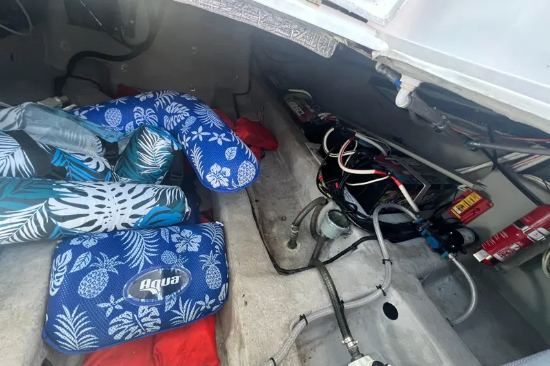 Slide: The Image of Interior of 2024 NX Boats 290 Exclusive showing storage and electrical components. - 51