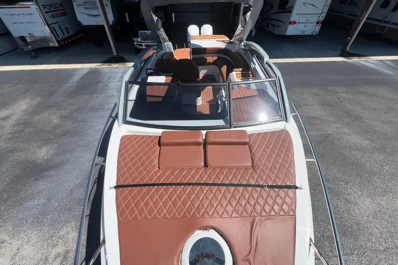 Slide: The Image of 2024 NX Boats 290 Exclusive with brown leather seating and sleek design. - 62