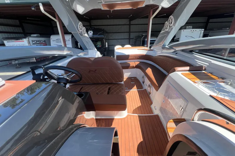 Slide: The Image of 2024 NX Boats 290 Exclusive interior with luxurious seating and modern design. - 64