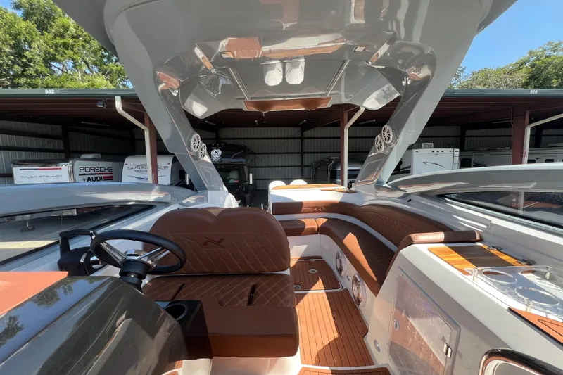 Slide: The Image of 2024 NX Boats 290 Exclusive interior with luxurious seating and modern design features. - 65