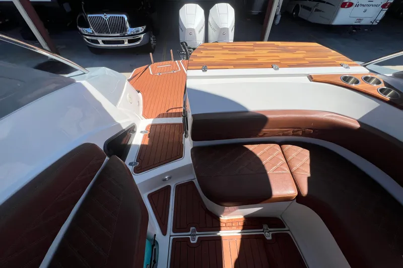 Slide: The Image of 2024 NX Boats 290 Exclusive interior with luxurious seating and wood accents. - 68