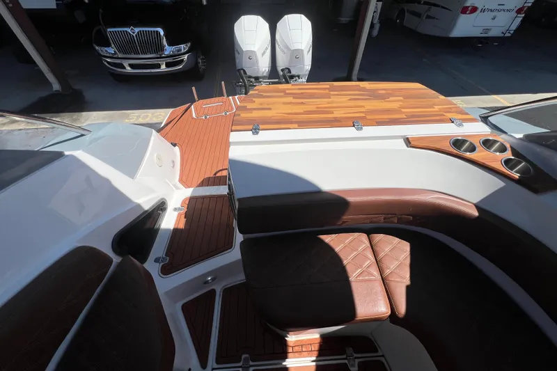 Slide: The Image of 2024 NX Boats 290 Exclusive interior with brown leather seating and wood accents. - 69