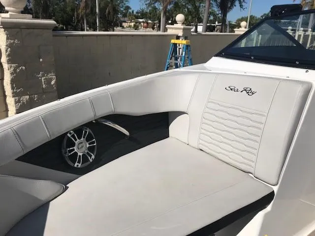 Slide: The Image of 2022 Sea Ray SPX 190 OB boat interior with white seating and logo. - 19