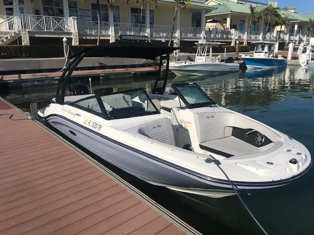 Slide: The Image of 2022 Sea Ray SPX 190 OB boat docked at marina, featuring sleek design and spacious seating. - 2